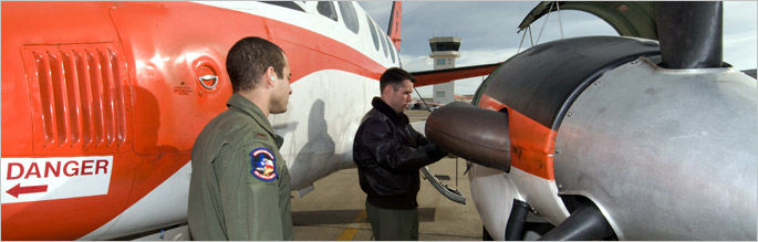 naval aviators perform pre-flight checks on aircraft