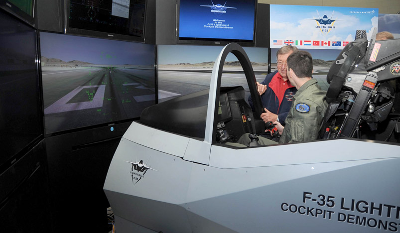 A naval aviator at Naval Air Station Meridian receives an overview of the F-35 Cockpit Demonstrator.
