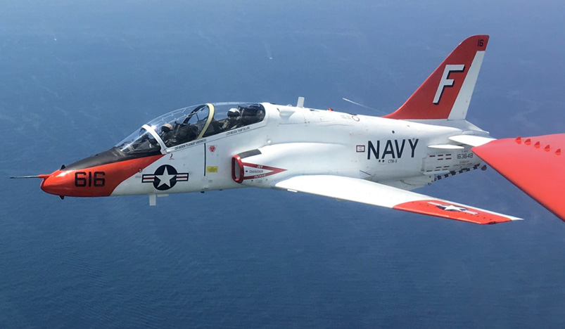 A NASA astronaut candidate and LCDR Easterling, an instructor with Trawing 6, conduct a preflight check of the cockpit of a T-6A Texan II.